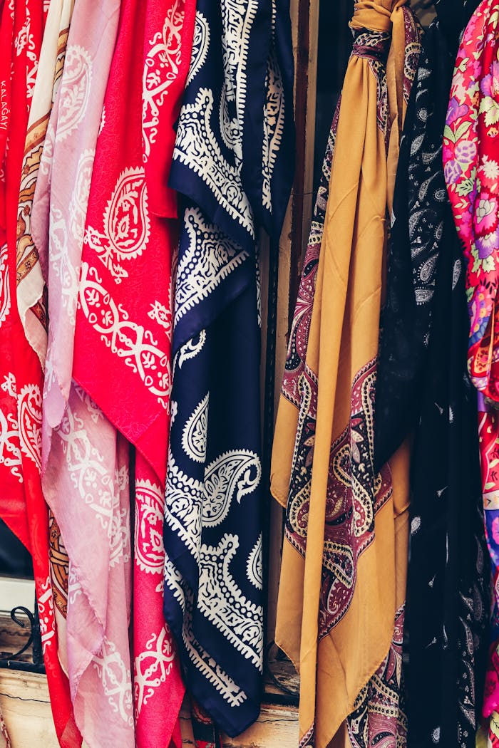 services-02 Vibrant handmade shawls on display at a market in Baku, showcasing intricate designs and rich colors.